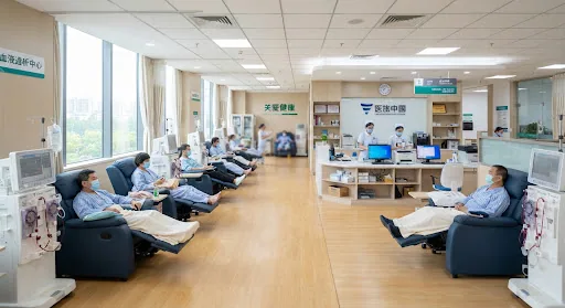 Spacious state-of-the-art hemodialysis ward with comfortable ergonomic recliners, advanced dialysis machines, clean medical aesthetic, and clinical nursing station