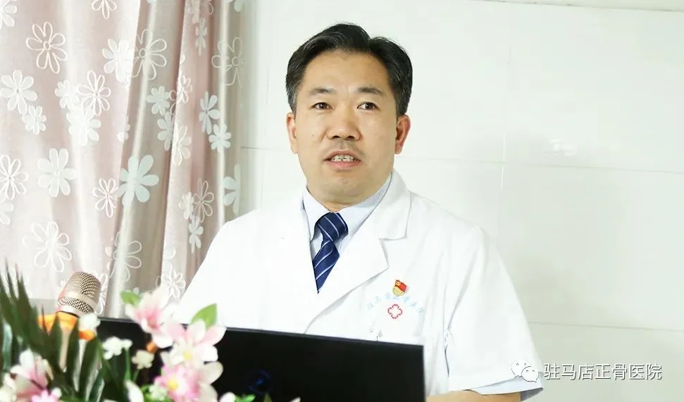 Senior male orthopedic surgeon hospital director in modern clinical attire, trustworthy and empathetic expression, medical conference background.